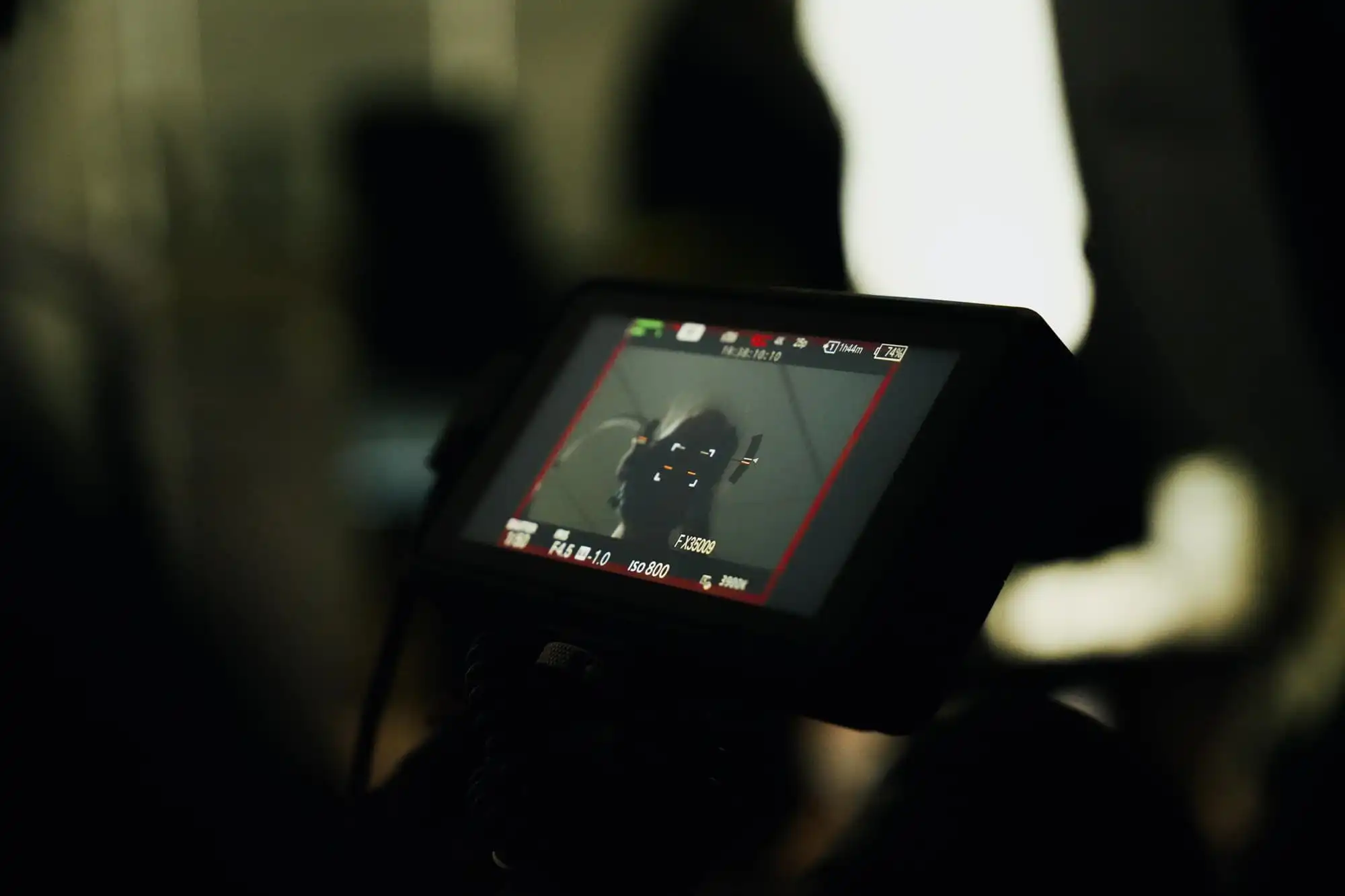 Close-up of a camera screen displaying a person in motion, possibly during a workout or exercise session.